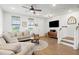 Cozy living room features a comfortable sectional sofa, wood flooring, and ample natural light at 557 Blueway Ave, Summerville, SC 29486