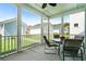 Relaxing screened patio with seating area, perfect for enjoying outdoor living, with views of neighboring homes at 557 Blueway Ave, Summerville, SC 29486