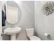 Charming powder room features modern fixtures, decorative mirror, and stylish wall art at 557 Blueway Ave, Summerville, SC 29486