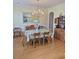 Bright dining room featuring a chandelier, hardwood floors, and classic wooden furniture at 605 Pointe Of Oaks Rd, Summerville, SC 29485