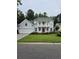 Charming two-story home with well-manicured lawn and inviting red front door at 605 Pointe Of Oaks Rd, Summerville, SC 29485