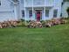 Charming home exterior with well-maintained lawn and beautiful flower bushes at 605 Pointe Of Oaks Rd, Summerville, SC 29485