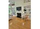 Bright living room featuring a fireplace, built-in bookshelves and hardwood flooring at 605 Pointe Of Oaks Rd, Summerville, SC 29485
