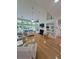 Spacious living room with vaulted ceilings, built-in shelving, and large windows overlooking the backyard at 605 Pointe Of Oaks Rd, Summerville, SC 29485