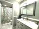 Bathroom with modern vanity, mirror, and shower with patterned curtain at 6212 Fieldstone Cir, Charleston, SC 29414