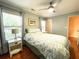 Cozy bedroom with floral bedding, a ceiling fan, and two bright windows at 6212 Fieldstone Cir, Charleston, SC 29414