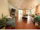 Spacious living room with hardwood floors, fireplace, and view of the sunroom at 6212 Fieldstone Cir, Charleston, SC 29414