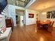 Open concept living room with hardwood floors leading to the dining area and a glimpse of the backyard at 6212 Fieldstone Cir, Charleston, SC 29414