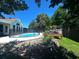 Backyard swimming pool with deck, patio, and lush landscaping on a sunny day at 6212 Fieldstone Cir, Charleston, SC 29414