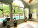 Sun room with a view of the pool featuring tile floors, large windows, and plant accents at 6212 Fieldstone Cir, Charleston, SC 29414