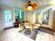 Inviting sunroom with tiled floors, multiple doors to the outside, a ceiling fan, and comfortable seating at 6212 Fieldstone Cir, Charleston, SC 29414