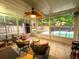Bright sunroom with views of the pool, tiled floors, comfortable seating, and access to the backyard at 6212 Fieldstone Cir, Charleston, SC 29414