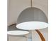 A pair of modern light fixtures reflect in a round mirror above a gray vanity at 705 Williamson Dr # C, Mount Pleasant, SC 29464