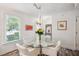 Bright dining area features hardwood floors, modern lighting, and a round glass-top table with comfortable seating at 705 Williamson Dr # C, Mount Pleasant, SC 29464