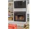 Close-up of a living room fireplace with a tv, decor and built-in shelving plus comfortable seating at 705 Williamson Dr # C, Mount Pleasant, SC 29464