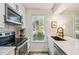 Bright kitchen features stainless steel appliances, modern fixtures, and white cabinets with marble countertops at 705 Williamson Dr # C, Mount Pleasant, SC 29464