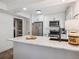 Kitchen with stainless steel appliances, white cabinets, marble countertops, modern fixtures, and open shelving at 705 Williamson Dr # C, Mount Pleasant, SC 29464