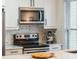 Close-up of a kitchen features marble countertops, modern appliances, stainless steel fixtures, and white cabinets at 705 Williamson Dr # C, Mount Pleasant, SC 29464