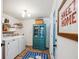 A laundry room boasts a washer, dryer, and a striking blue cabinet with glass doors at 705 Williamson Dr # C, Mount Pleasant, SC 29464