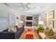 Bright living room with hardwood floors, comfortable seating, a ceiling fan, and a fireplace with shelving at 705 Williamson Dr # C, Mount Pleasant, SC 29464