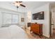 Bright main bedroom with wood floors, ceiling fan, and a flat screen television at 705 Williamson Dr # C, Mount Pleasant, SC 29464
