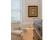 Corner of bright main bedroom with hardwood floors and a comfortable seating area by the window at 705 Williamson Dr # C, Mount Pleasant, SC 29464