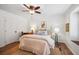 Bright main bedroom with hardwood floors, ceiling fan, and a comfortable seating area by the window at 705 Williamson Dr # C, Mount Pleasant, SC 29464