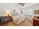 Bright main bedroom with hardwood floors, ceiling fan, and a comfortable seating area by the window at 705 Williamson Dr # C, Mount Pleasant, SC 29464
