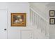White staircase highlighted by framed art hanging on the walls at 705 Williamson Dr # C, Mount Pleasant, SC 29464