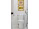 A white toilet sits below a pair of framed flower prints at 705 Williamson Dr # C, Mount Pleasant, SC 29464