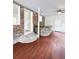 Open basement layout featuring a wet bar, steps to another level, and hardwood flooring at 710 Gadsden Loop, Walterboro, SC 29488