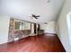 Basement area with wood floors, brick accent wall with bar, and white door at 710 Gadsden Loop, Walterboro, SC 29488
