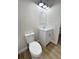 Bathroom featuring a white vanity, toilet, mirror, and modern lighting at 710 Gadsden Loop, Walterboro, SC 29488
