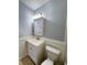 Bathroom featuring a white vanity with mirror cabinet, toilet, and beadboard trim at 710 Gadsden Loop, Walterboro, SC 29488
