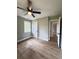 Bedroom features light green walls, wood-look floors, a ceiling fan, and a bright window at 710 Gadsden Loop, Walterboro, SC 29488