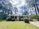 Charming brick home with a well-manicured lawn and mature trees providing shade at 710 Gadsden Loop, Walterboro, SC 29488