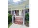 Welcoming front porch with brick steps and elegant white railings leading to front door at 710 Gadsden Loop, Walterboro, SC 29488