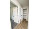 Hallway featuring wood-look flooring, access to closet, and two rooms with neutral paint colors at 710 Gadsden Loop, Walterboro, SC 29488