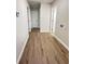 Hallway with wood-look flooring and white doors leading to various rooms in the house at 710 Gadsden Loop, Walterboro, SC 29488