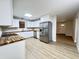 Open kitchen with stainless steel appliances, white cabinets, and butcher block countertops at 710 Gadsden Loop, Walterboro, SC 29488