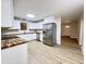 Open kitchen with stainless steel appliances, white cabinets, and butcher block countertops at 710 Gadsden Loop, Walterboro, SC 29488