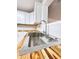 Close-up of stainless sink and faucet with butcher block countertops and white cabinets at 710 Gadsden Loop, Walterboro, SC 29488