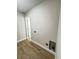 Bright laundry room with utility connections and wood-look flooring at 710 Gadsden Loop, Walterboro, SC 29488