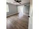 Open living room featuring wood-look flooring, ceiling fans, and natural light from windows at 710 Gadsden Loop, Walterboro, SC 29488