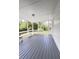Covered screened porch featuring painted wood flooring and built-in bench seating at 710 Gadsden Loop, Walterboro, SC 29488