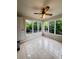 Cozy sunroom featuring tile flooring, ceiling fan, and natural light from surrounding windows at 710 Gadsden Loop, Walterboro, SC 29488