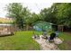 Spacious backyard with a fire pit area, a deck, and a mural-covered building at 716 White Oak Dr, Charleston, SC 29407