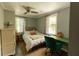 Bright bedroom with a ceiling fan, two windows, desk, and area rug at 716 White Oak Dr, Charleston, SC 29407