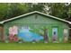 Mural of flowers, trees and animals on the side of a building in the backyard at 716 White Oak Dr, Charleston, SC 29407