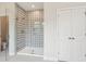 Modern bathroom featuring a glass-enclosed shower with a stylish tile design and storage closet at 735 Breakers Reef Ln, Huger, SC 29450